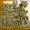 carved heads in clay